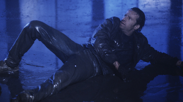 Connor lying wet on the ground in "Highlander" (1986)