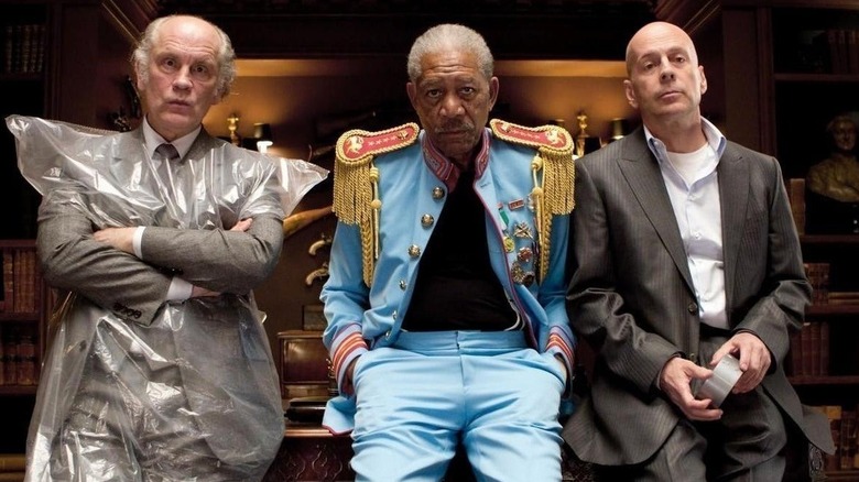 Marvin, Joe, and Frank sit on a desk in "Red" (2010)