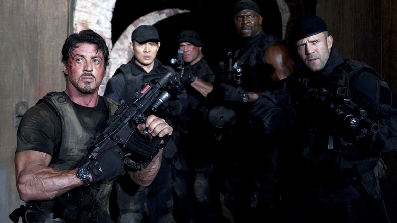 Barney and crew move armed through a tunnel in "The Expendables" (2010)