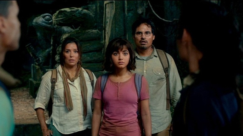 Dora and her parents stand in front of two rivals in an ancient temple in Dora and the Lost City of Gold (2019)