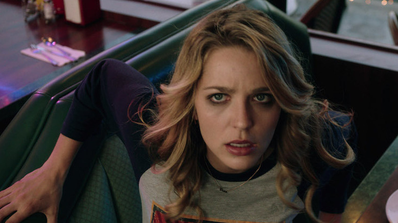 Tree looks up in shock from a diner booth in "Happy Death Day" (2017)