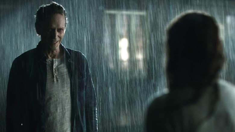 The Pale Man confronts Lisa in the rain in "Haunter" (2013)