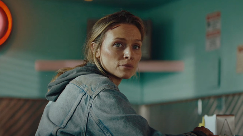 Irene sits at a diner counter and looks over her shoulder in "Redux Redux" (2025)
