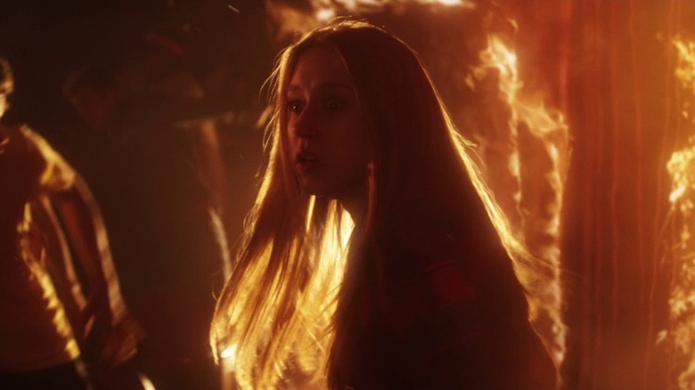 Max walks through a home engulfed in flames in "The Final Girls" (2015)