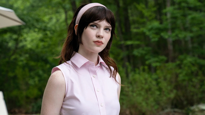 Iris in a pink outfit with a pink headband looking up at something in Companion