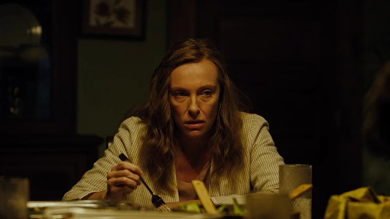 Annie at the dinner table looking angry in Hereditary