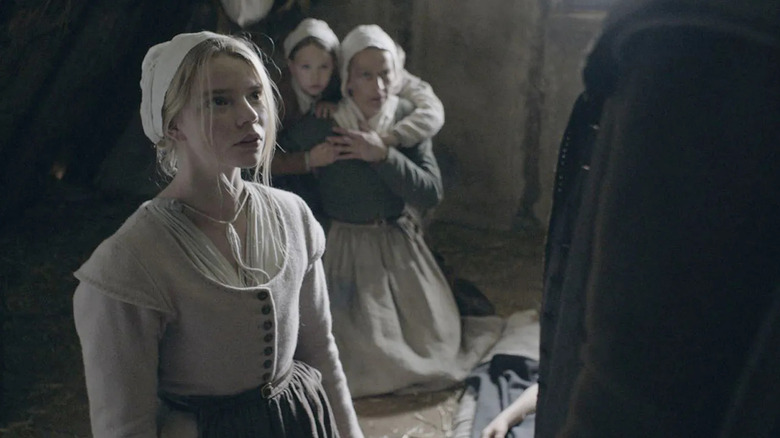Thomasin looking up at someone scared in The Witch