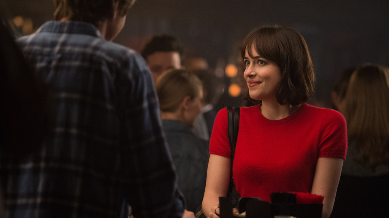 Alice in a red top talking to someone at a party in How to Be Single