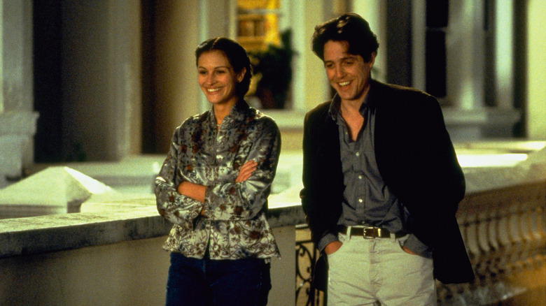 Anna and William laughing and walking down the street in Notting Hill