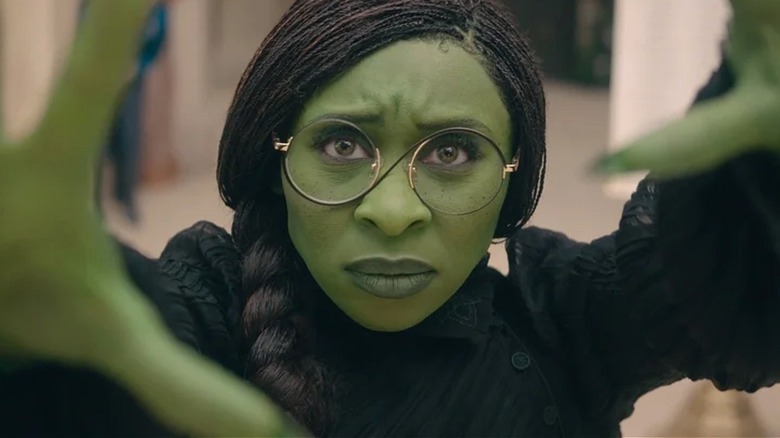 Elphaba stretches out her arms in 