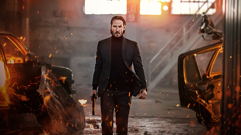 John Wick walks through a burning garage in "John Wick" (2014)