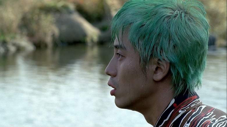 Ryu wades through water in "Sympathy for Mr. Vengeance" (2002)