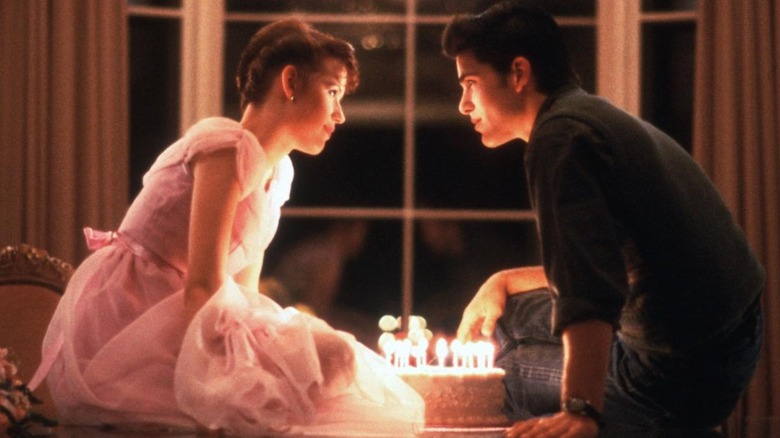 Sam and Jake looking at each other over cake in "Sixteen Candles."