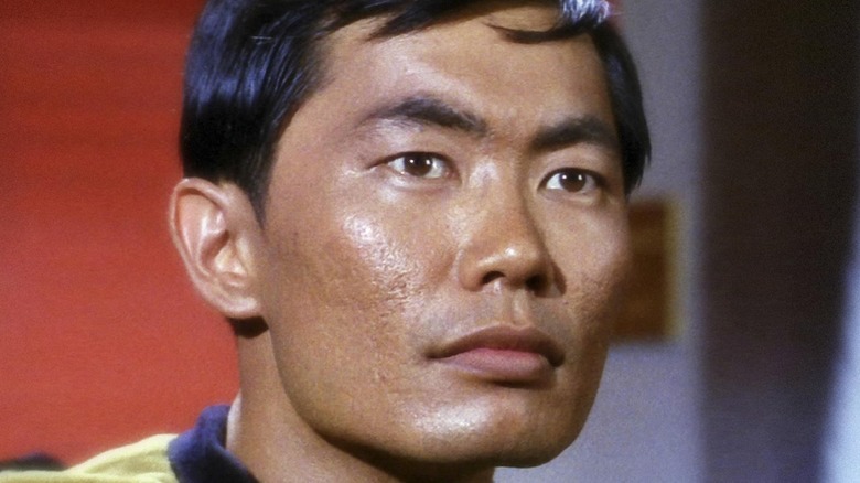 George Takei seriously looks off to side