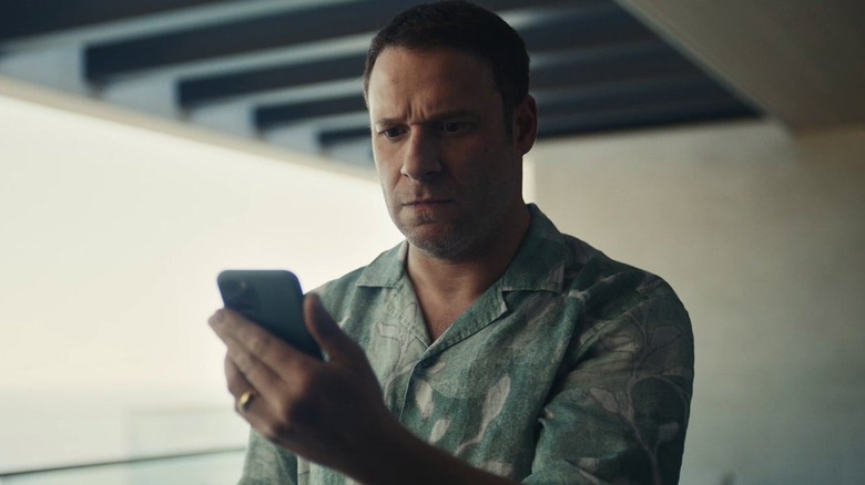 Gabe Plotkin stares at his phone in "Dumb Money" (2023)