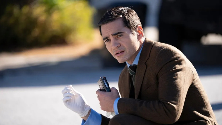 Will with a recording device and a glove on looking worried on Will Trent