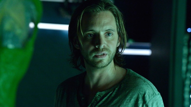Cole bathed in green light in "12 Monkeys" (2015-2018)