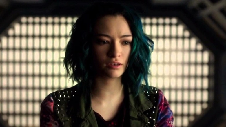Five stands in front of a grate panel in "Dark Matter" (2015-2017)