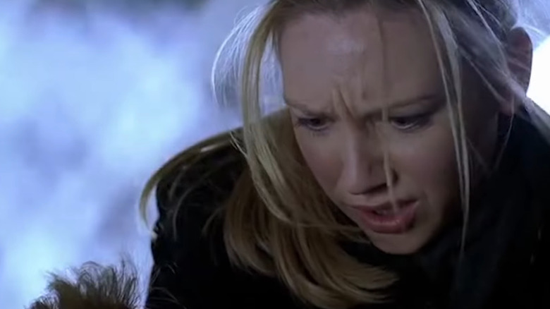 Olivia looking down at someone