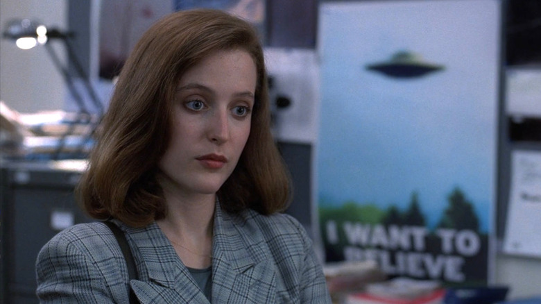 Dana standing in front of UFO poster