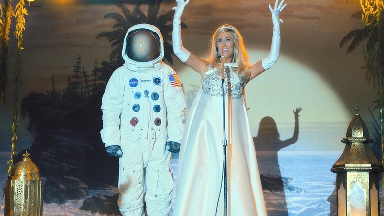 Maxine holds up her arms on stage in Palm Royale (2024)