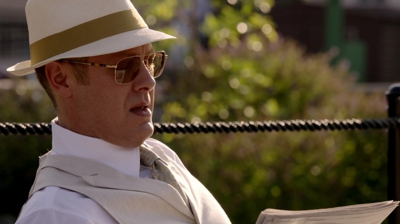Raymond Reddington reading on a park bench in The Blacklist (2013 - 2023)