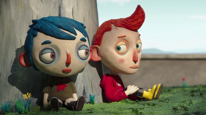 Courgette and Camille sitting by a tree in "My Life as a Zucchini"