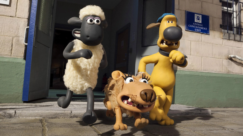 Shaun, Bitzer, and Slip running out of a building in "Shaun the Sheep Movie"
