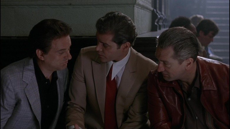 Tommy DeVito, Henry Hill, and Jimmy Conway huddled together in "Goodfellas"