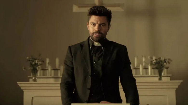 Jesse stands behind a lecturn giving a sermon in Preacher