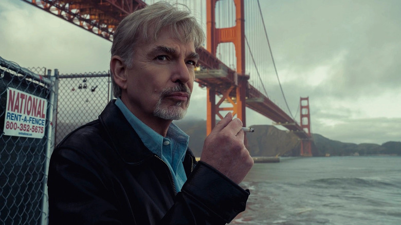 McBride smokes a cigarette in front of the Golden Gate Bridge in Goliath