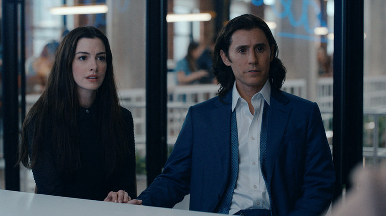 Adam and Rebekah sit at a board room table in WeCrashed