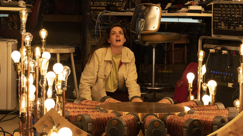 Leah surrounded by lightbulbs in "Solos."