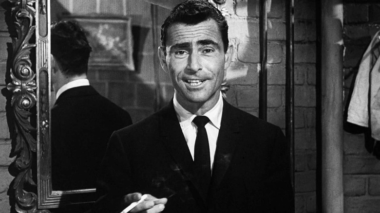 Rod Serling standing in front of a mirror with a cigarette in "The Twilight Zone."