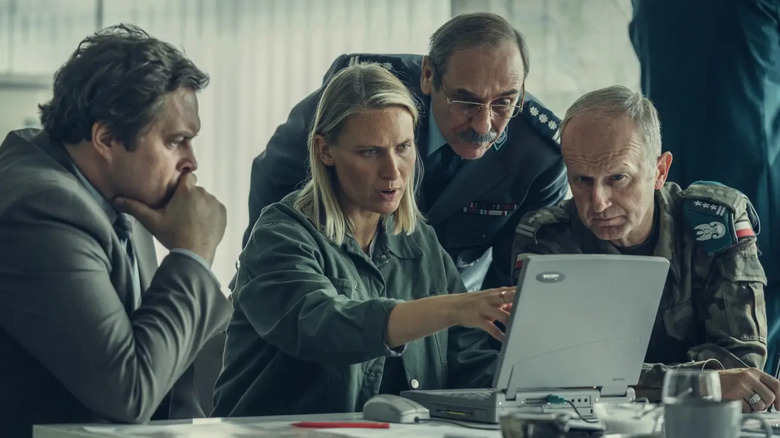 Tremer explains the data on her laptop to a team of officials in High Water