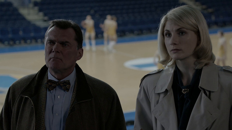 Grimes and O'Neill stand in a stadium in The Assets