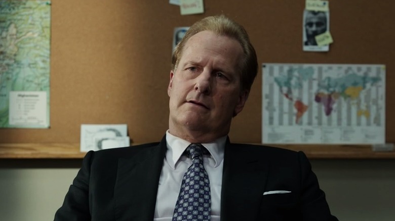 O'neill leans back in his chair and tilts his head in concern in The Looming Tower
