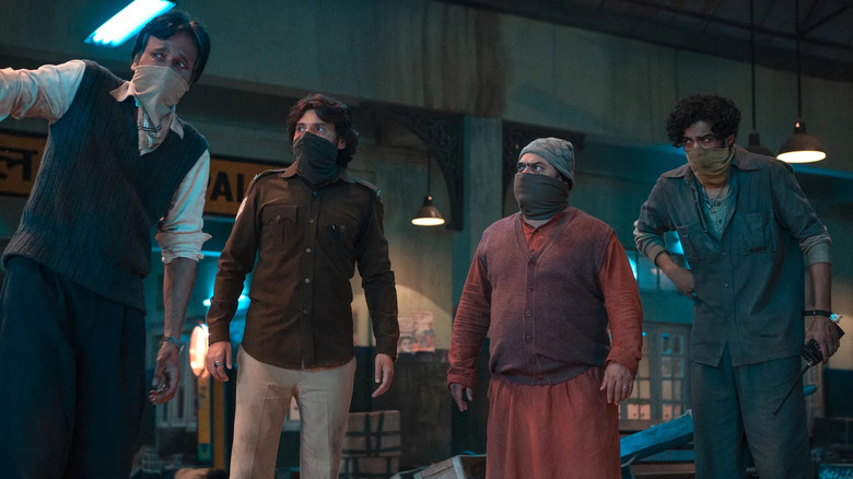 Four railway workers discuss the problem in The Railway Men