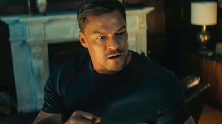 Jack holds up his fists in Reacher