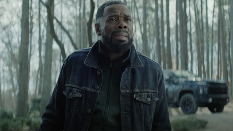 Muncie stands in the woods looking worried in The Madness