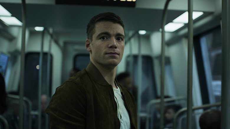 Peter stands on a bus in the Night Agent