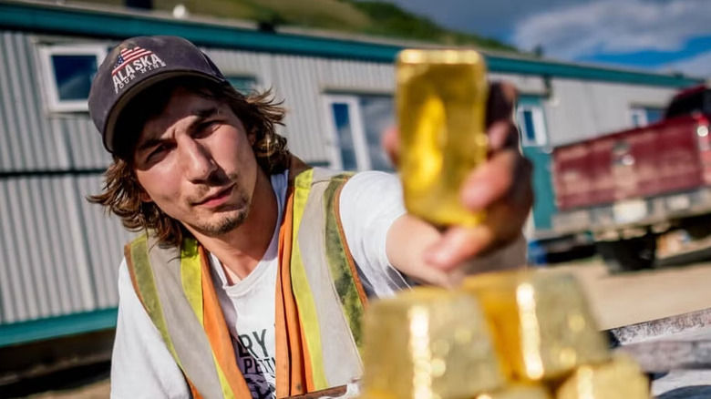 Parker Schanbel holds up some gold bars in "Gold Rush" (2010-present)