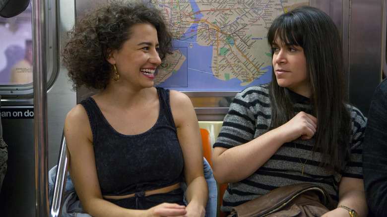 Ilana and Abbi laughing on the subway on Broad City