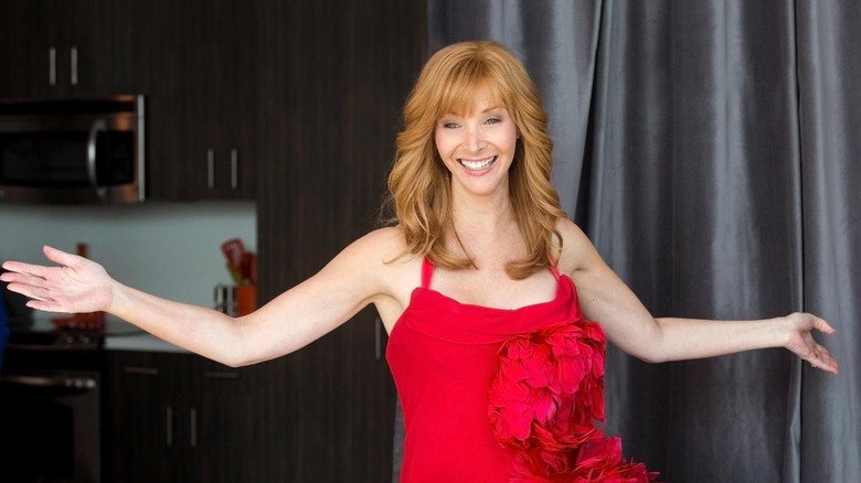 Valerie Cherish posing in a red dress on The Comeback