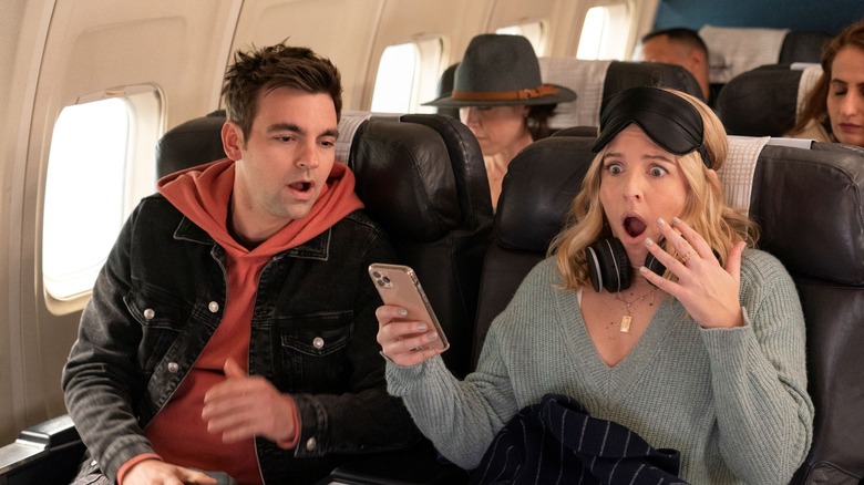Cary and Brooke looking shocked on a plane on The Other Two
