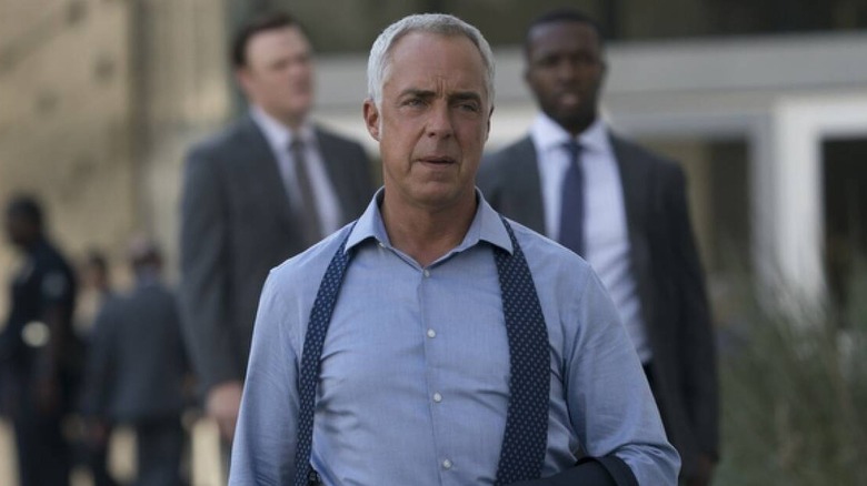 Bosch walks towards the screen with tie undone in Bosch