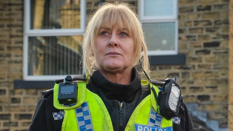 Cawood stands in front of a brick home on Happy Valley