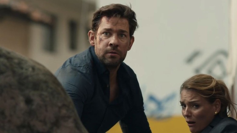 Jack Ryan furrows his brow, covered in dirt, in Jack Ryan