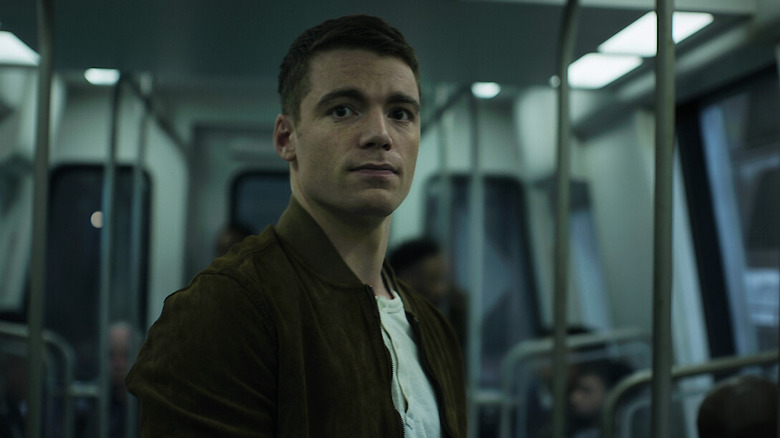Sutherland stands on a subway car in The Night Agent