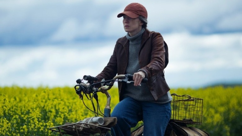 Nora riding a bike through a field in The Leftovers